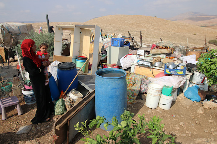 A Palestinian woman examines the damage in her residential structure following an Israeli demolition in Al Hadidiya, Jordan Valley, West Bank, October 11, 2018. (Ahmad al-Bazz/Activestills.org)