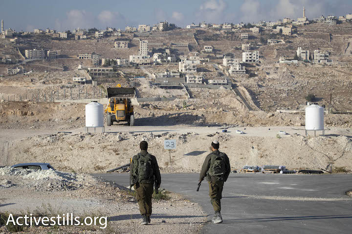 Israeli soldiers seen guarding al-Jabal, the area designated for Khan al-Ahmar's evacuees, in East Jerusalem October 13, 2018. (Oren Ziv/Activestills.org)