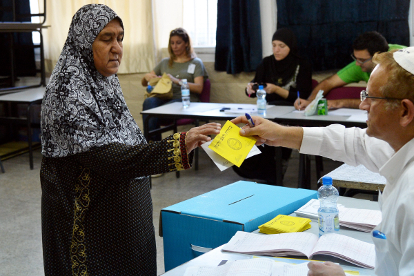 An Arab woman casts her vote at a polling station in the mixed Jewish-Arab city of Lyd on October 22, 2013. (Yossi Zeliger/Flash90)