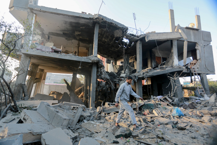 A Palestinian man walks through the wreckage of a building that was damaged by Israeli air strikes in Khan Yunis, in the southern Gaza Strip, on November 13, 2018. (Abed Rahim Khatib/Flash90)