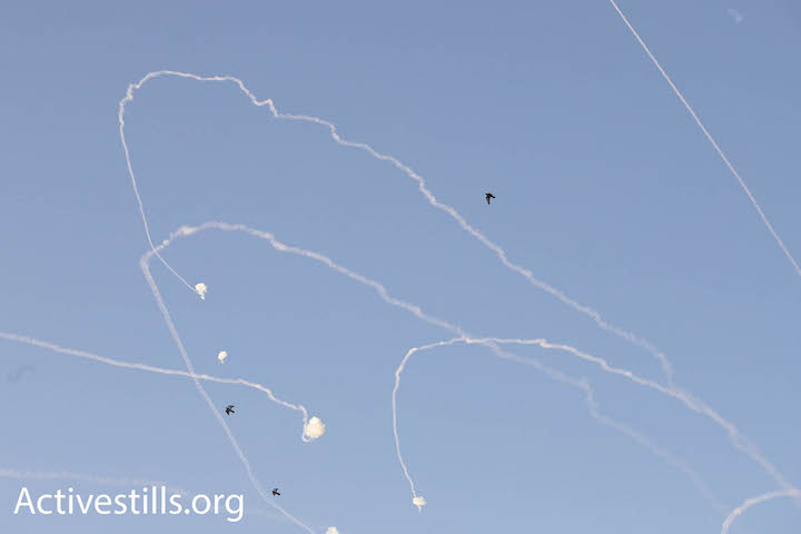Smoke trails and explosions caused by Iron Dome interceptions of rockets from Gaza are seen over the Israeli city of Ashkelon Tuesday morning. (Oren Ziv/Activestills.org)