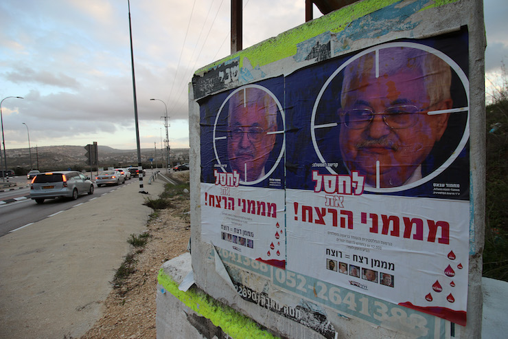 Posters, calling for the assassination of Palestinian President Mahmoud Abbas, are seen on Road 60, near Nablus in the northern West Bank, December 12, 2018. (Ahmad Al-Bazz/Activestills.org)