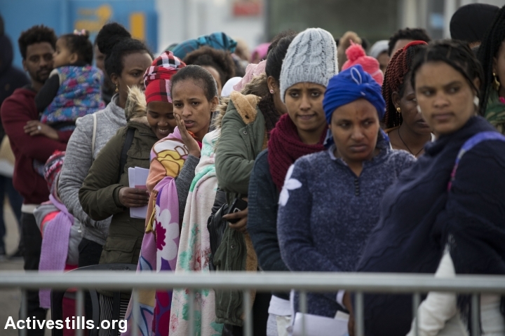 Asylum seekers from Sudan and Eritrea wait in line to enter the Ministry of Interior in the city of Bnei Brak, in order to renew their temporary visas or submit their asylum requests, in the early morning hours of February 4, 2018. (Oren Ziv/Activestills.org)