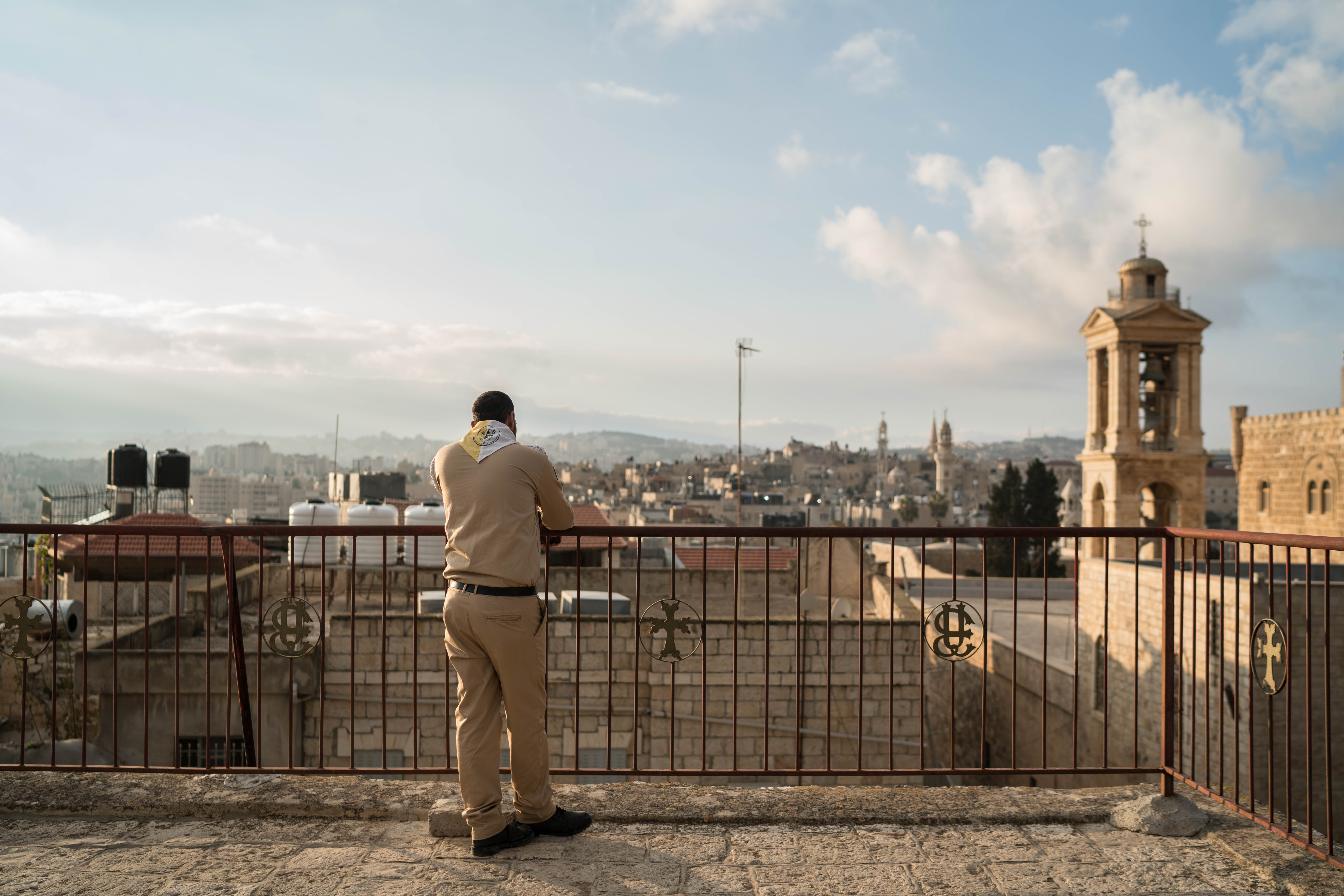 Yousef Tarazi, dressed in his scouts uniform, looks over the city of Bethlehem on December 24, 2018.