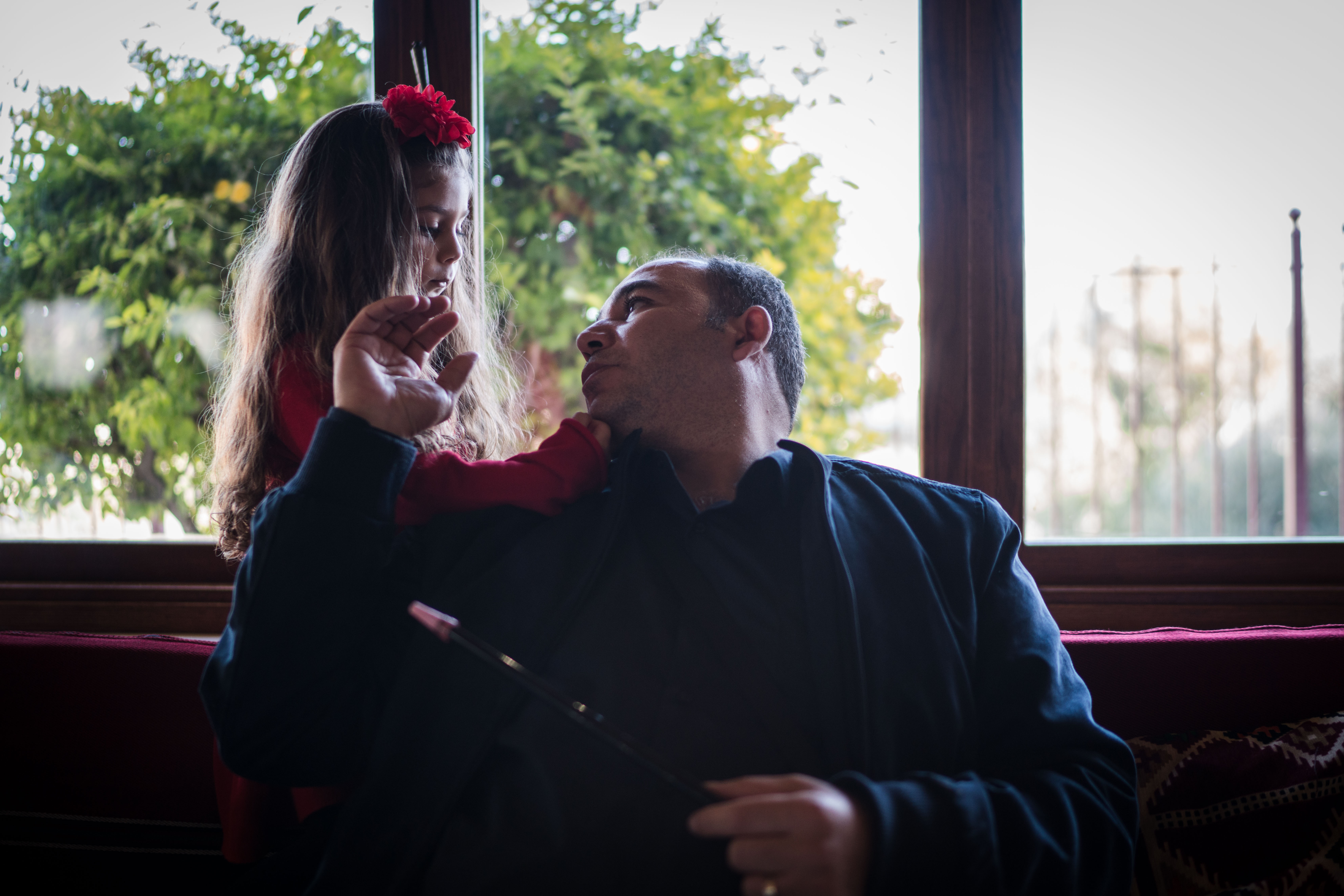 George Antone shares a moment with his daughter during their Christmas lunch in Bethlehem on December 25, 2018.