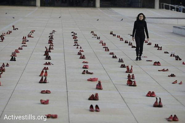 Feminist activists paint hundreds of pairs of shoes red to protest gender violence, Tel Aviv, December 4, 2018. (Oren Ziv/Activestills.org)
