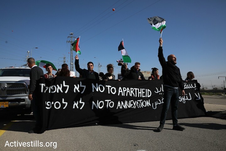 Palestinian and Israeli activists block Route 4370 in the West Bank, dubbed the 'apartheid road,' just east of Jerusalem, January 23, 2019. (Oren Ziv/Activestills.org)