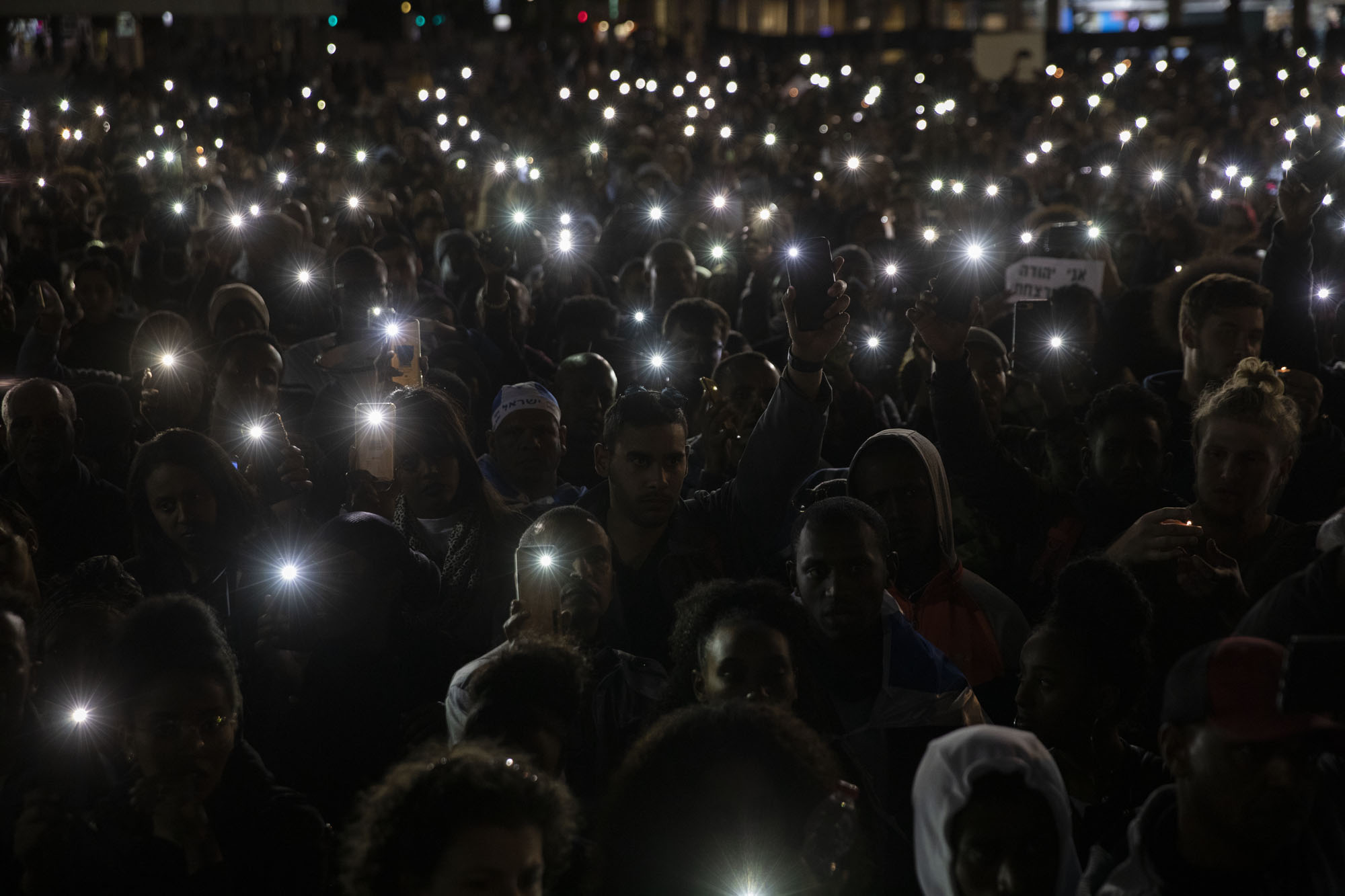 Thousands of Ethiopian Israelis and their supporters marched against police violence in Tel Aviv on Jan. 30, 2018, weeks following the fatal police shooting of Yehuda Biadga. The protests ended with a vigil in Rabin Square. (Activestills.org/Oren Ziv)