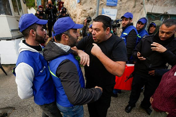 Israeli Settler Ofer Ohana argues with Palestinian activists in the West Bank city of Hebron, February 10, 2019. (Wisam Hashlamoun/Flash90)