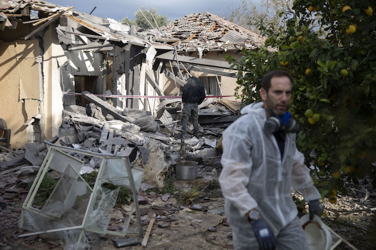 Israeli security forces assess the damage to a home in central Israel that was destroyed by a rocket fired overnight from Gaza, Mishmarot, March 25, 2019. (Oren Ziv/Activestills.org)