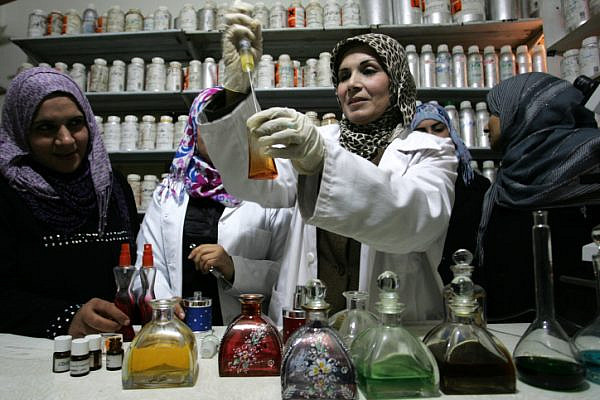 Palestinian women working in a small laboratory manufacturing perfumes at the Rafah refugee camp in the southern Gaza Strip on January 8, 2012. (Abed Rahim Khatib/Flash90)