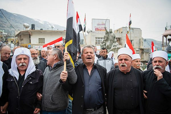Members of the Druze community in the Golan Heights protest the decision of President Donald Trump to recognize Israeli sovereignty in the territory, Majdal Shams, March 23, 2019. (Basel Awidat/Flash90)