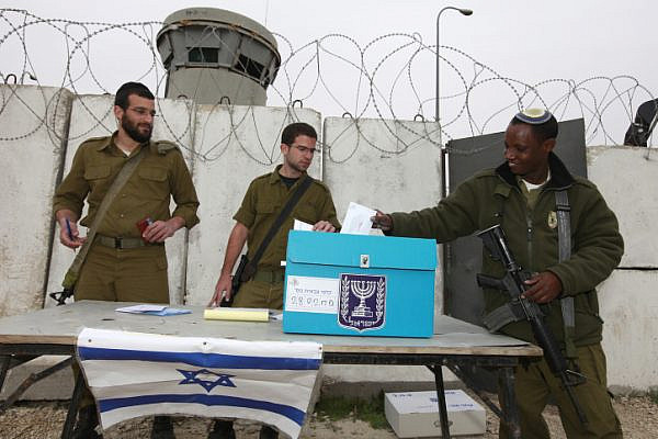 Illustrative photo of Israeli soldiers voting at a portable ballot box, near Bethlehem in the West Bank. (Nati Shohat/Flash90)