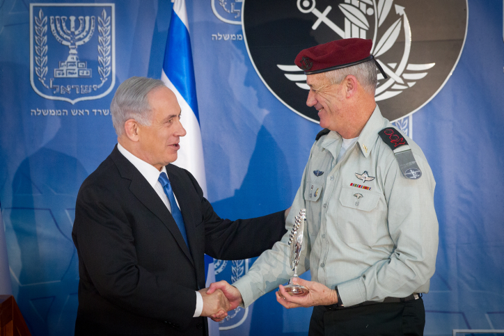 Outgoing IDF Chief of Staff Benny Gantz seen with Israeli prime minister Benjamin Netanyahu at a ceremony held in honour of incoming IDF chief of staff Gadi Eizenkot (not seen) at a ceremony held in Eizenkot's honour at the PM's office in Jerusalem, on February 16, 2015. Photo by Miriam Alster/FLASH90 *** Local Caption *** ??? ?????? ?????? ?????? ??? ??? ????? ??