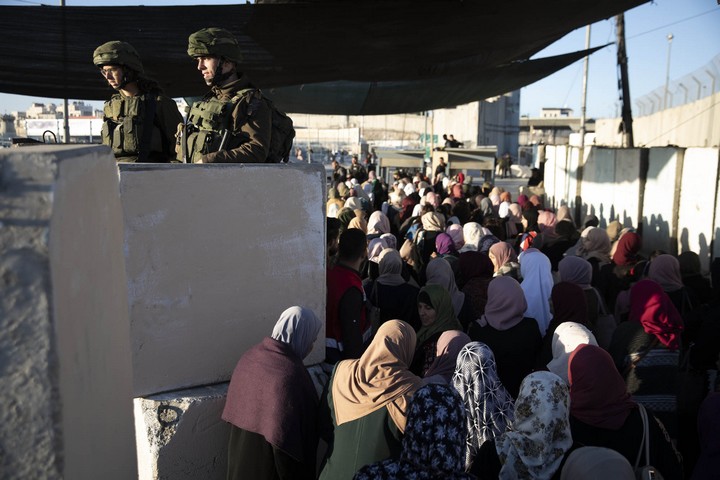 Palestinian women pass through Qalandiya checkpoint on the way to Jerusalem on the first Friday of Ramadan, May 10, 2019. (Oren Ziv/Activestills.org)