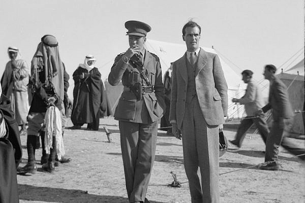 British diplomat John Holmes seen alongside a military officer during a tribal lunch at a cavalry post in Tel al-Meleiha, 20 miles north of Be'er Sheba, January 18, 1940. (Library of Congress)