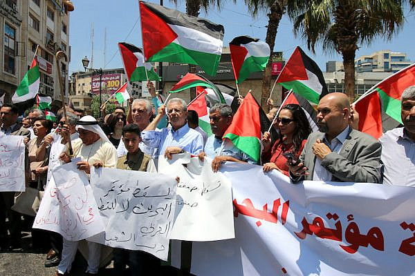 Palestinians in Ramallah protesting the U.S.-led economic workshop, to be held in Bahrain as part of the Trump administration's "Deal of the Century" plan for ending the conflict, June 15, 2019. (Ahmad Al-Bazz/Activestills.org)