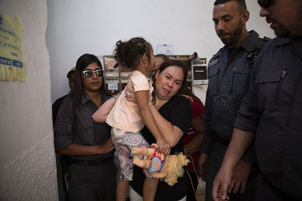 Israeli immigration agents arrest migrant worker Geraldine Esta and her daughters in their home in Ramat Gan, Israel, July 23, 2019. (Oren Ziv/Activestills.org)