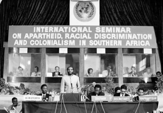 Simon KAPWEPWE (standing), Foreign Minister of Zambia, addressing the Seminar on Apartheid, Racial Discrimination and Colonialism. 4/Aug/1967 (UN Photo)