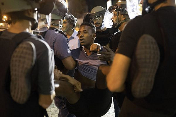 Israeli police remove an Ethiopian-Israeli from a demonstration on Ayalon Highway following the police shooting of Solomon Tekah, July 2, 2019. (Oren Ziv/Activestills.org)