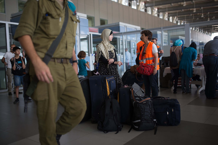 Palestinians wait at the Erez crossing between Gaza and Israel on July 13, 2014. (Flash90)