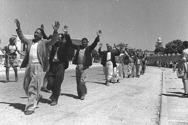 Palestinians in the city of Ramle surrender to Israeli forces during 1948 war. (Eldad David/GPO)