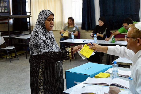 An Arab woman casts her vote at a polling station in the city of Lyd on October 22, 2013. (Yossi Zeliger/Flash90)