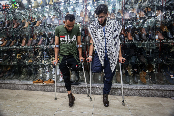 Young Palestinians Mohammed Ehsen, 21, Bassem Abu Ubaid, 33 , who had their legs amputated following injuries during the Great Return March, Gaza Strip, on June 3, 2019. (Abed Rahim Khatib/ Flash90)