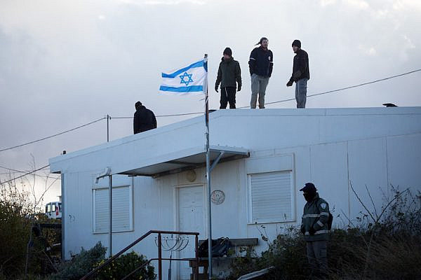Jewish settlers prepare to resist an evacuation operation at the illegal outpost of Amona, February 1, 2017. (Miriam Alster/FLASH90)