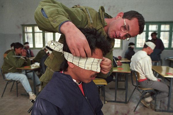 Illustrative photo of an Israeli soldier blindfolding a Palestinian prisoner. (Nati Shohat/Flash90)