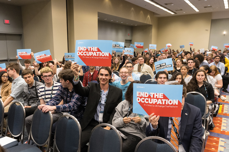 Attendees at the 2019 J Street National Conference raise posters of the organization's new campaign urging the Democratic Party to formally oppose Israel's occupation of Palestinian territory, October 27, 2019. (Photo courtesy of J Street)