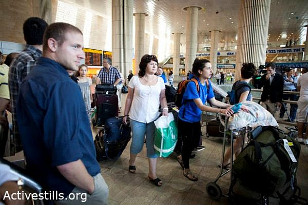 Tourists being watched by security forces at Ben Gurion airport, June 8 2011 (photo: Oren Ziv / activestills)