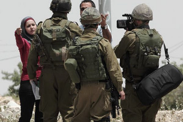 Soon to be pixilated? IDF gunmen, led by a Lt. Col., harrassing journalists in Al Ma'asara (Photo: Yossi Gurvitz)