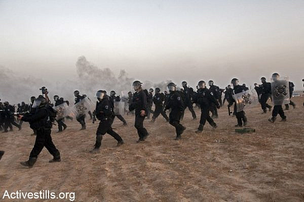 Israeli policemen march through the village of Al Araqib during the first demolition of the village in July 2010.