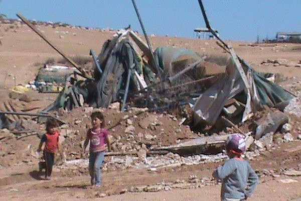 Palestinian children n front of their destroyed home in Zenuta, August 28 2012 (Operation Dove)