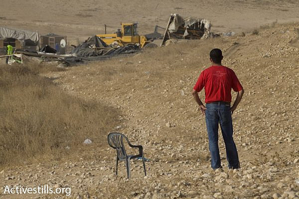 A Bedouin man surveys the demolition of his village, Al Araqib, July 27, 2010 (Photo: Activestills.org)