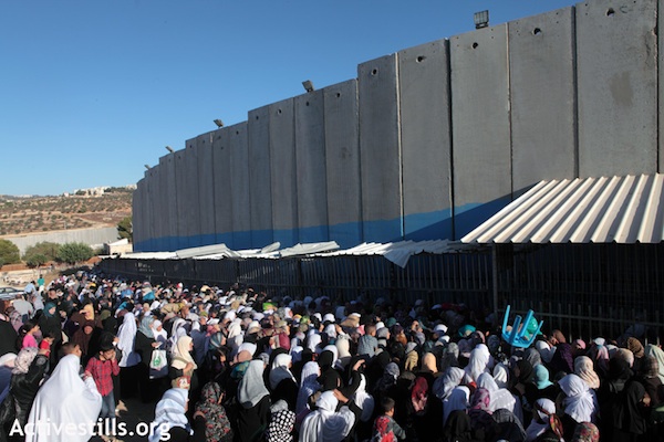 Palestinians wait to get through at checkpoint at the separation wall in Bethlehem [file photo], (Photo: Activestills.org)