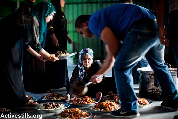 Residents of the unrecognized Bedouin village of Al Arakib prepare food for the Iftar meal, breaking the fast during the month of Ramadan, as Bedouins and activists gather to mark three years to the first demolition of the village, July 27, 2013. Photo by: oren ziv/Activestills.org