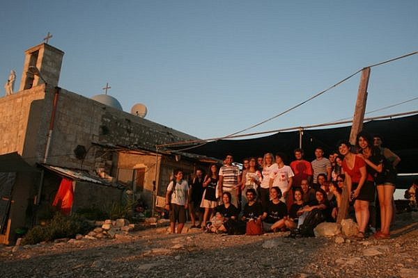 The two summer camps outside the Iqrit church at sunset (Haggai Matar)