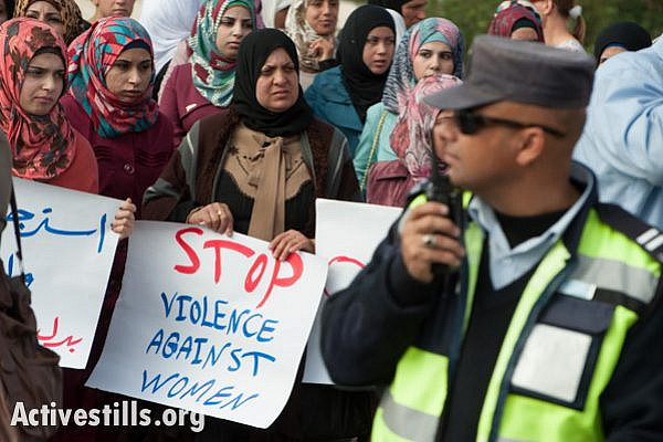 Women from the West Bank town of Bethlehem march past Palestinian Authority policemen during a protest against honor killings and other forms of violence against women, November 16, 2013. (photo: Ryan Rodrick Beiler/Activestills.org)