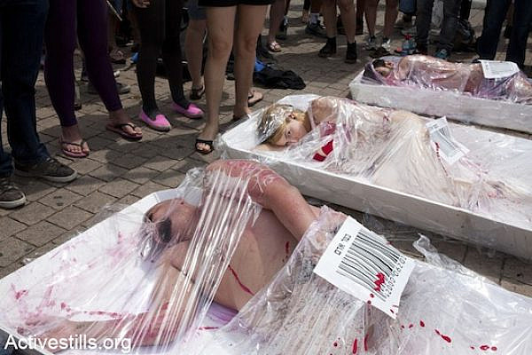 Animal rights activists wrapped in plastic packaging with barcoded 'human flesh' stickers, resembling slabs of meat in the market, during a protest organized by the 269life group.