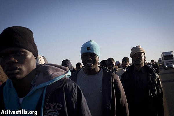 African Asylum seekers take part in a protest march on the highway from Be'er Sheva in southern Israel on their way to Jerusalem on December 16, 2013 after they fled a detention centre in the south where they were being held. 