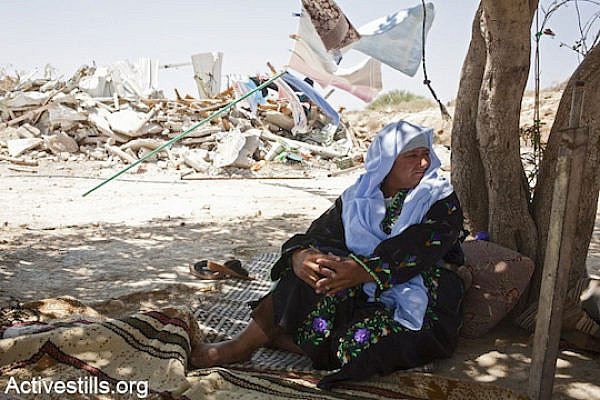 Sanda Abulkian sits outside her demolished house in the unrecognized village of Atir on July 12, 2013. The Abulkian house has demolished four times already, three of them during 2013. (Photo: Keren Manor/Activestills.org)