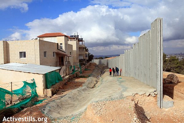 The separation wall being built in al-Walaja, December 7, 2010. Once completed, the wall will completely surround the village. (Photo by Anne Paq/Activestills.org)