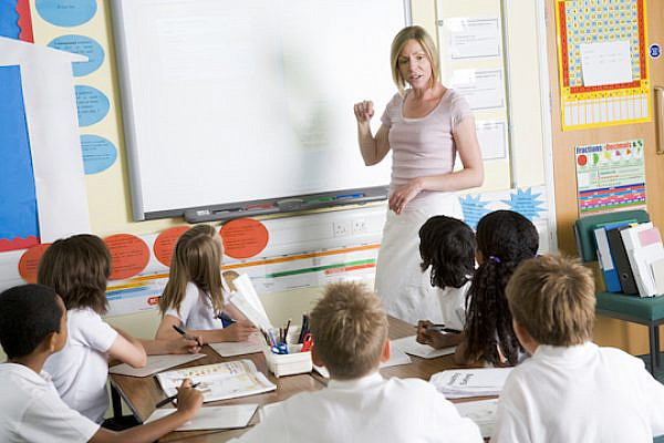 Illustrative photo of school children and a teacher in class (Photo by Shutterstock.com)