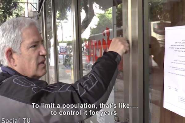 A Tel Aviv storeowner finds a fake military directive, ordering him to close his shop. The notice was put up by anti-occupation activists to commemorate 20 years since the Cave of the Patriarchs massacre, which led to the closing of Hebron's main street. (YouTube screenshot)