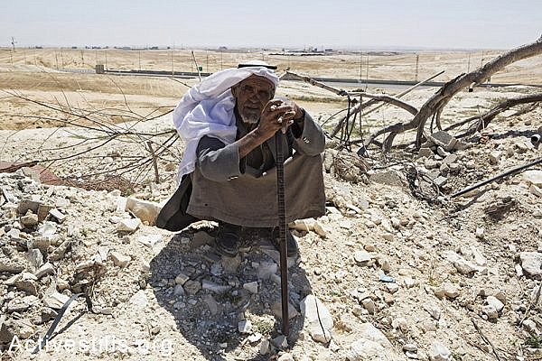 A man from the Zanoun family sits next to the ruins of his house a few hours after it was demolished in the unrecognized bedouin village of Wadi Al Na'am, Negev Desert, May 18, 2014. A women with her 5 children, the oldest of them is 5 years old, were living in the house demolished by the Israeli Land Administration. Wadi Al-am is the largest unrecognized village in Israel, with estimated 13,000 residents, most of them are internally displaced. The village is not connected to electricity. (Activestills.org)