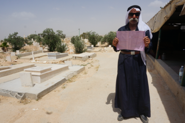 Sheikh Sayah A-Turi holds up an eviction notice in his village of Al-Arakib. (photo: Michal Rotem)