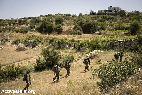 Israeli soldiers enter the city of Halhul, near Hebron, in a search for the three kidnapped teenagers. (photo: Activestills)