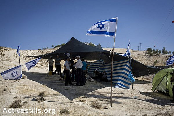 Israeli right wing activists are seen at the outpost they built in the E1 area outside the settlement of Maale Adumim in response to the murder of the three kidnapped Israeli teenagers on July 1, 2014 in the West-bank. (Oren Ziv/Activestills.org)